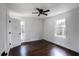 Bedroom featuring wood floors, ceiling fan, and a window offering views of the surrounding trees at 3280 Hazelwood Sw Dr, Atlanta, GA 30311