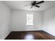 Bright bedroom featuring wood floors, ceiling fan, and a window allowing for plenty of natural light at 3280 Hazelwood Sw Dr, Atlanta, GA 30311