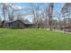 Well-maintained home featuring dark exterior brick, mature trees, and a sprawling green front lawn at 3280 Hazelwood Sw Dr, Atlanta, GA 30311