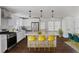 Modern kitchen with white cabinets, stainless steel appliances, an island with barstool seating, and wood floors at 3280 Hazelwood Sw Dr, Atlanta, GA 30311