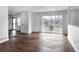 Open living room with hardwood floors, sliding glass doors, and a neutral color palette at 3280 Hazelwood Sw Dr, Atlanta, GA 30311