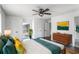 Main bedroom featuring wood floors, ample closet space, ceiling fan, and modern mid-century decor at 3280 Hazelwood Sw Dr, Atlanta, GA 30311