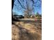 A home with a long driveway and ample parking, surrounded by trees at 3814 Rex Rd, Rex, GA 30273