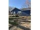 Charming home featuring navy blue siding, a wooden deck, and well-maintained landscaping at 3814 Rex Rd, Rex, GA 30273