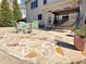 A stone patio featuring green chairs, table, and swing set, with a potted plant adding to the ambiance at 5066 Healey Dr, Smyrna, GA 30082