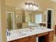 Bright bathroom vanity with a large mirror, soaking tub and glass-enclosed shower at 5066 Healey Dr, Smyrna, GA 30082