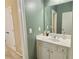 Well-lit bathroom featuring a white vanity, sink, and large mirror with a neutral wall color at 5066 Healey Dr, Smyrna, GA 30082