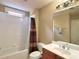 Bathroom featuring a shower/tub combo, toilet, vanity with sink, mirror, and window at 5066 Healey Dr, Smyrna, GA 30082