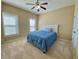 Cozy bedroom featuring natural light, a ceiling fan, carpeted floors, and a comfortable bed at 5066 Healey Dr, Smyrna, GA 30082