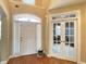 Elegant foyer boasts a striking entry door with sidelights and decorative transom, next to glass french doors at 5066 Healey Dr, Smyrna, GA 30082