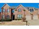 Charming brick home featuring three car garage, shutters, and manicured landscaping at 5066 Healey Dr, Smyrna, GA 30082