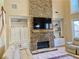Impressive stone fireplace with built-in shelving in a spacious living room, perfect for cozy evenings at 5066 Healey Dr, Smyrna, GA 30082