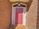 Charming brick home featuring a welcoming front entrance with a classic, pink-colored door and decorative transom window at 5066 Healey Dr, Smyrna, GA 30082