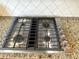 A stainless steel KitchenAid cooktop is set in granite countertops at 5066 Healey Dr, Smyrna, GA 30082