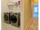 Bright laundry room featuring a side-by-side washer and dryer with overhead storage space at 5066 Healey Dr, Smyrna, GA 30082