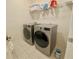 Functional laundry room featuring a side-by-side washer and dryer with overhead storage at 5066 Healey Dr, Smyrna, GA 30082