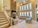 Sunlit living room with a striking fireplace, tall windows, and a cozy sectional sofa, perfect for gatherings at 5066 Healey Dr, Smyrna, GA 30082