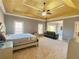 Large main bedroom suite with tray ceiling, ceiling fan, and sitting area at 5066 Healey Dr, Smyrna, GA 30082