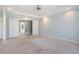 Expansive bedroom with neutral carpet, tray ceiling, and doors that lead to another room at 1032 Lena Nw St, Atlanta, GA 30314