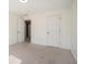 Clean, carpeted bedroom with 2 white doors and neutral wall color at 1032 Lena Nw St, Atlanta, GA 30314