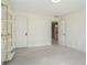 Clean, carpeted bedroom with an open doorway and custom gold and white shelving at 1032 Lena Nw St, Atlanta, GA 30314