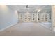 Expansive main bedroom with carpet, tray ceiling, fan and French doors to private balcony at 1032 Lena Nw St, Atlanta, GA 30314