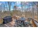 View of a back deck featuring outdoor furniture and a grill, backing onto a wooded area at 2139 Golden Morning Ct, Kennesaw, GA 30152