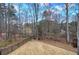 Picturesque backyard with a tranquil view of the woods and lake, framed by an elegant wrought-iron fence at 2139 Golden Morning Ct, Kennesaw, GA 30152