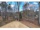 Private backyard bordered by trees and a black metal fence, providing a peaceful natural setting for relaxation at 2139 Golden Morning Ct, Kennesaw, GA 30152