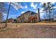 Backyard view of a home, showcasing a spacious lawn area with a deck and a distant wooden fence at 2139 Golden Morning Ct, Kennesaw, GA 30152