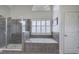 Bright bathroom featuring a soaking tub, glass-enclosed shower, and neutral tile at 2139 Golden Morning Ct, Kennesaw, GA 30152