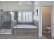 Bathroom with tiled floor, garden tub, and glass shower stall at 2139 Golden Morning Ct, Kennesaw, GA 30152