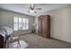 Bedroom featuring an antique armoire, shuttered windows, and neutral carpet at 2139 Golden Morning Ct, Kennesaw, GA 30152