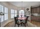 Sunlit breakfast nook with round table and chairs, adjacent to the kitchen with brown cabinetry at 2139 Golden Morning Ct, Kennesaw, GA 30152