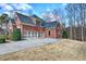 Exterior view of home, highlighting its brick facade, two-car garage, and landscaping at 2139 Golden Morning Ct, Kennesaw, GA 30152
