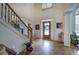 Grand foyer entrance featuring hardwood floors, elegant staircase, and stylish front door at 2139 Golden Morning Ct, Kennesaw, GA 30152