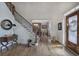 Inviting foyer features gleaming hardwood floors, staircase with decorative iron railings, and views into the formal dining room at 2139 Golden Morning Ct, Kennesaw, GA 30152