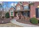 Charming front entrance featuring a brick porch, decorative columns, and a welcoming front door at 2139 Golden Morning Ct, Kennesaw, GA 30152