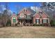 Stunning brick home with a well-manicured lawn and mature landscaping, evoking warmth and sophistication at 2139 Golden Morning Ct, Kennesaw, GA 30152