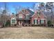 Attractive brick home with meticulous landscaping, featuring multiple gables and elegant arched windows at 2139 Golden Morning Ct, Kennesaw, GA 30152