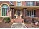 Up close, inviting front porch featuring wood columns and detailed brick work around a decorative front door at 2139 Golden Morning Ct, Kennesaw, GA 30152