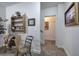 Neutral hallway showcasing rustic decor, wooden shelf, and a glimpse into a warmly lit room at 2139 Golden Morning Ct, Kennesaw, GA 30152