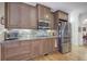 Kitchen featuring granite countertops, stainless steel appliances, and brown cabinets at 2139 Golden Morning Ct, Kennesaw, GA 30152