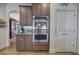 Close-up of kitchen double ovens and white pantry doors, complemented by dark cabinetry at 2139 Golden Morning Ct, Kennesaw, GA 30152
