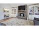 Comfortable living room with stone fireplace, shelving, and hardwood floors at 2139 Golden Morning Ct, Kennesaw, GA 30152