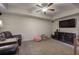 Relaxing living room with plush leather seating, a ceiling fan, and a large television for entertainment at 2139 Golden Morning Ct, Kennesaw, GA 30152