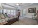 Spacious main bedroom featuring trey ceilings, neutral carpet, and a wall of windows that offer abundant natural light at 2139 Golden Morning Ct, Kennesaw, GA 30152