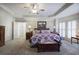 Bright main bedroom featuring plush carpeting, tray ceiling, and stylish furnishings at 2139 Golden Morning Ct, Kennesaw, GA 30152