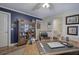 Spacious office with dark blue accent wall, hardwood floors, built-in cabinet, and desk with laptop at 2139 Golden Morning Ct, Kennesaw, GA 30152
