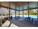 Covered poolside pavilion featuring stone details, ceiling fans, and picnic tables perfect for enjoying the pool area at 2139 Golden Morning Ct, Kennesaw, GA 30152